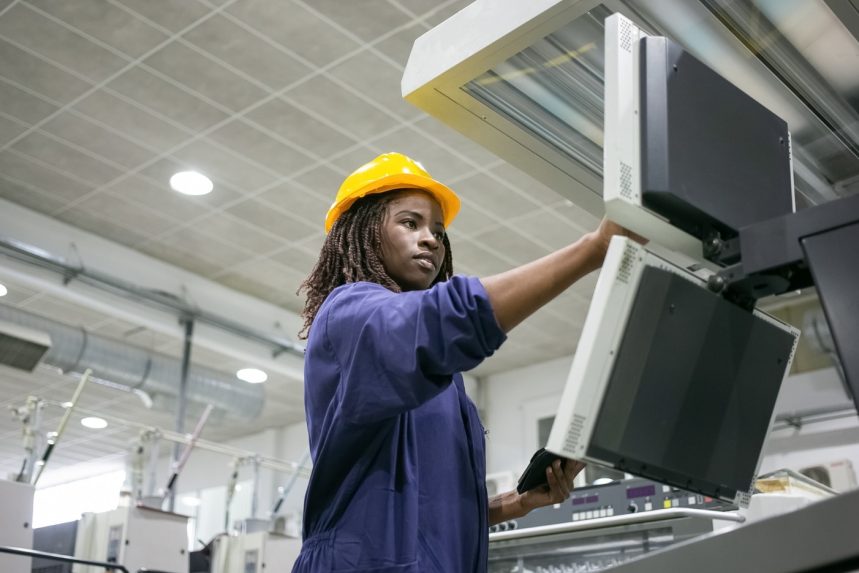 focused-confident-female-factory-worker-operating-industrial-machine-touching-control-board-using-tablet Globalquest Solutions